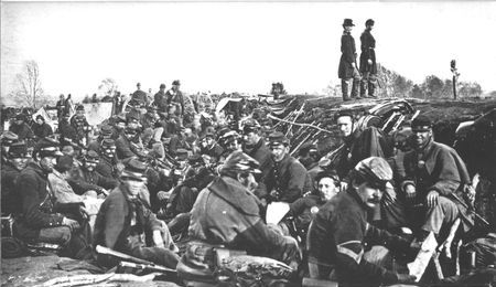 Assaults on fortified positions were costly, but here at Petersburg war-weary infantrymen await their turn for another charge
against the Confederate works. Fourteen out of every hundred would fall.