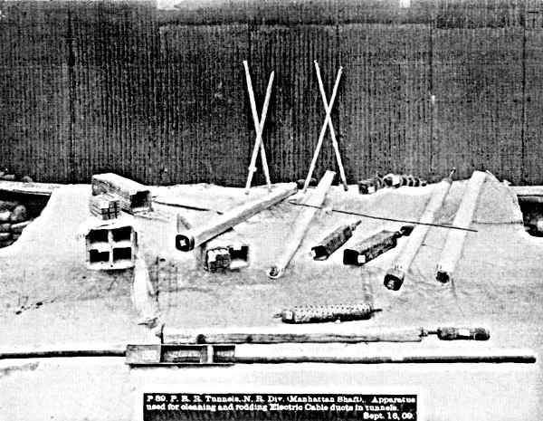 Apparatus for cleaning and rodding electric cable ducts
             in tunnel.