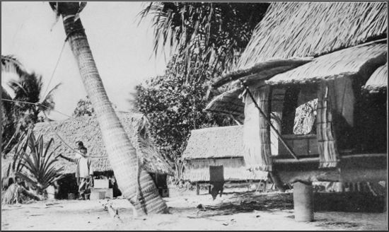 "Equator Town," showing corner of the
sleeping-house and cook-house